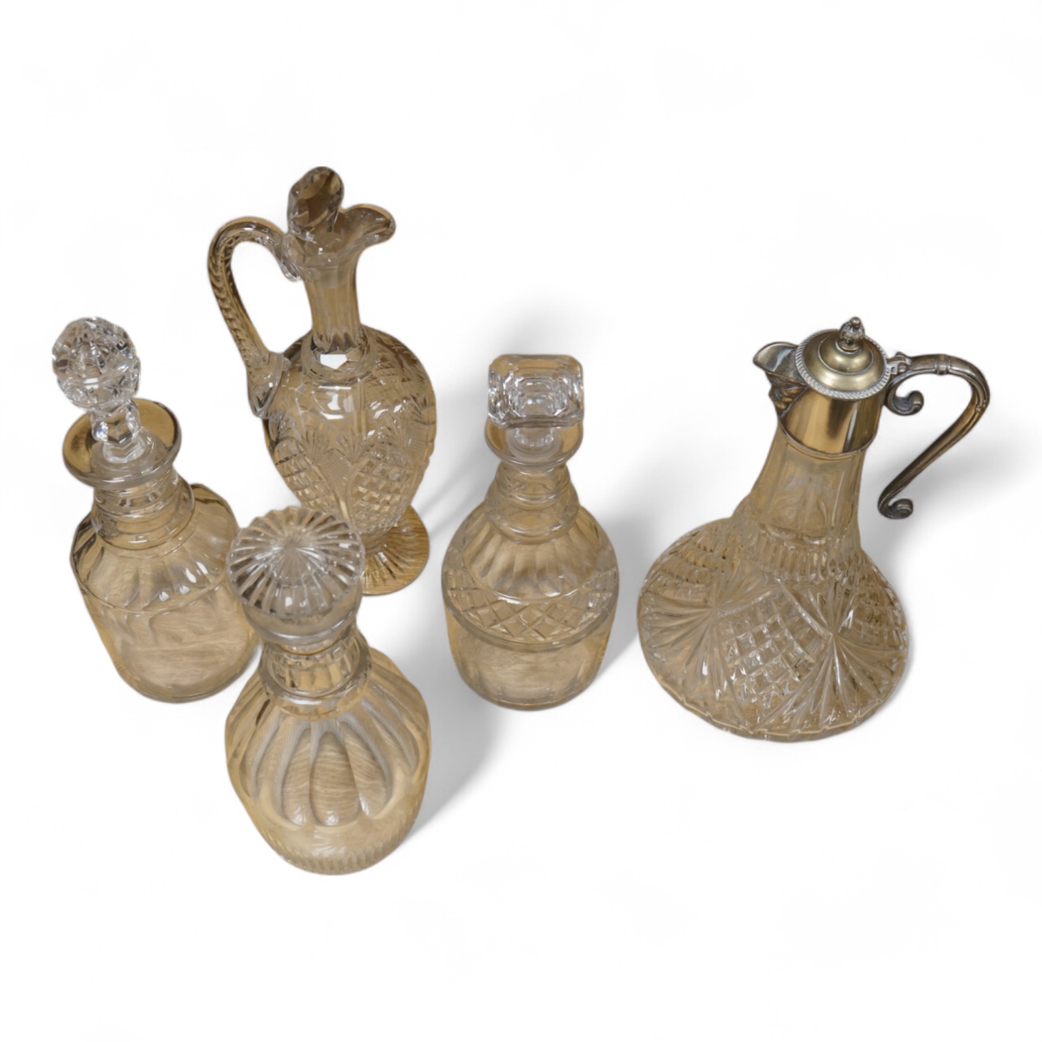 Three early 19th century cut glass decanters and two Victorian jugs, tallest 32cm
